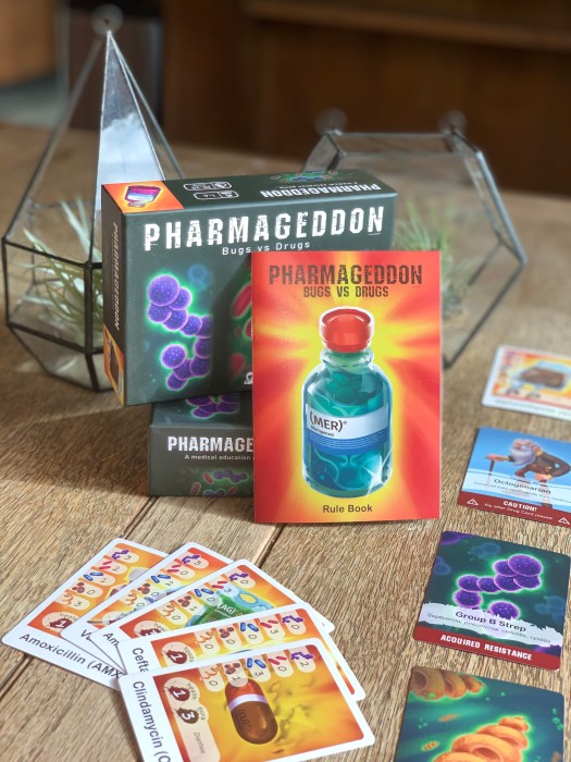 Image of Pharmageddon: Bugs vs Drugs on the table with rule book.